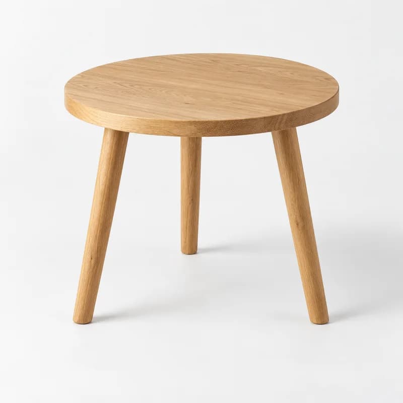 Round Nest Table in Natural Oak, isolated on a pale studio background